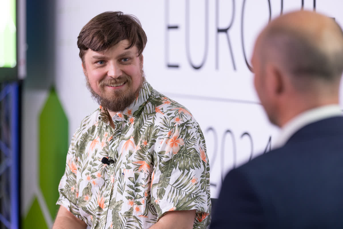 Filip Chyla on a panel at ISC2 Secure Europe, wearing his tropical conference shirt